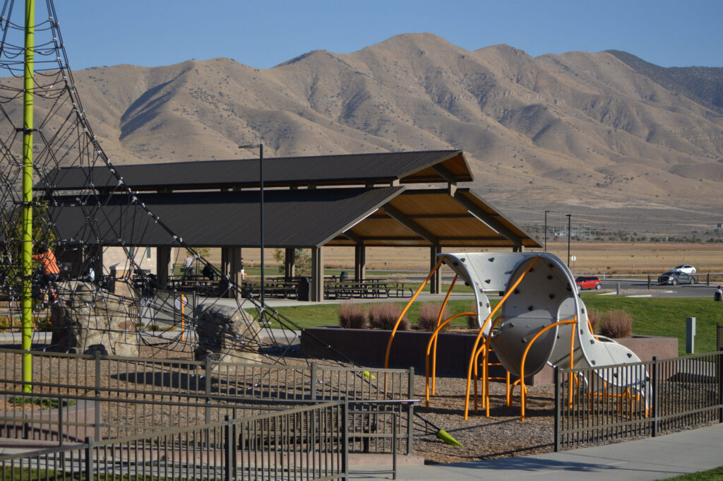 Families play in beautiful outdoor space at community event. Things to do in Utah.