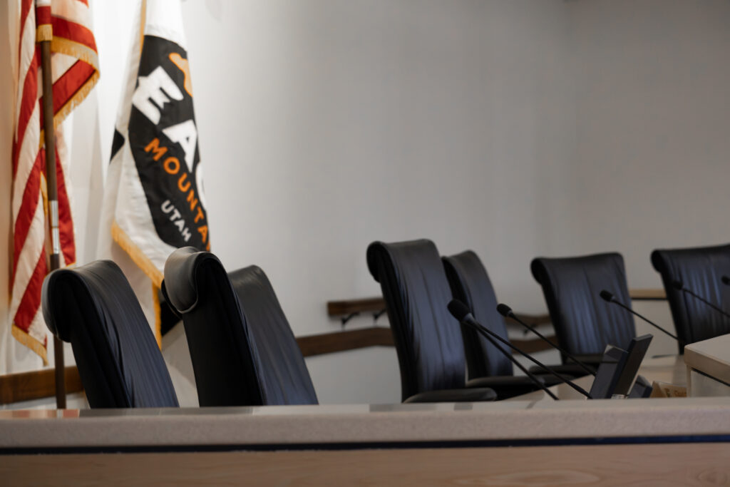 city council chambers empty chairs flags