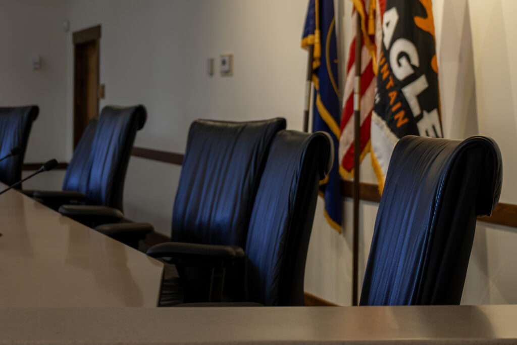 City Council Chambers Side View with chairs and flags