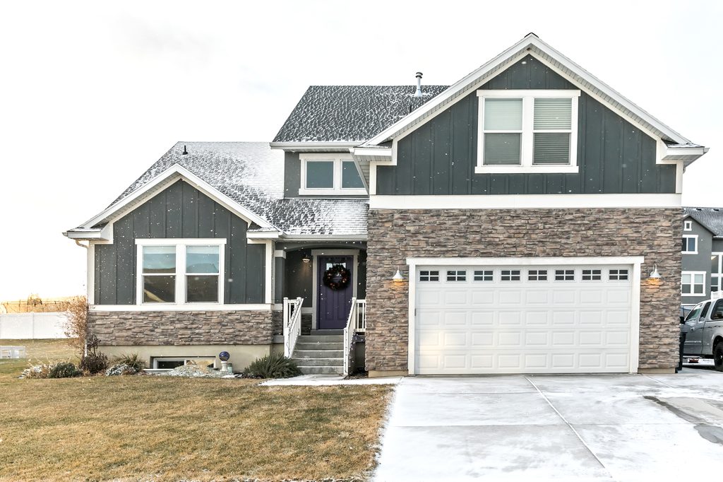 Home exterior in winter with show on the rooftop.